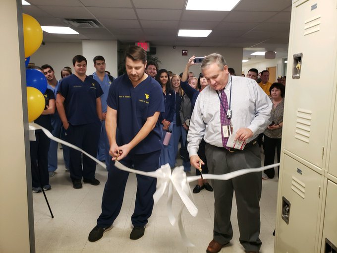 Dr. Borgia cuts the ribbon on new renovations.